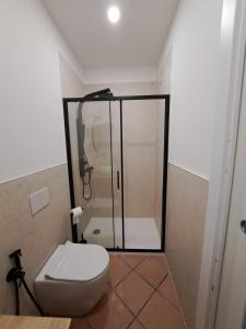 a bathroom with a toilet and a glass shower at GR room 22 in Sennori