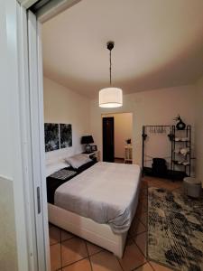 a bedroom with a bed and a pendant light at GR room 22 in Sennori