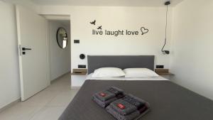 a bedroom with a bed with two pillows on it at Castelo View Luxury apt in Rhodes Town
