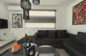 a living room with a couch and a glass table at Castelo View Luxury apt in Rhodes Town