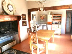 a dining room with a table and a fireplace at Port Nolloth Beach Shack in Port Nolloth