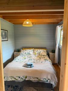 a bedroom with a bed and a light fixture at The Meadow in Lapworth