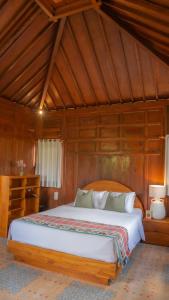 a bedroom with a large bed in a room at Villa Uma Sawan By 25Hours Hospitality in Bedahulu