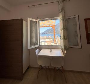 a table and two chairs in a room with a window at Sea View Studios, Harbour Beach, Bali in Bali +62 photos