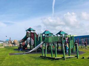 a playground with a slide in a park at Unique 2 bed lodge lyons Robinhood in Rhyl