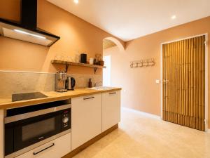 a kitchen with a sink and a stove top oven at Voyage à Bali in Sarreguemines