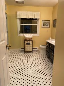 a bathroom with a black and white tiled floor at Downtown Halifax near waterfront in Halifax