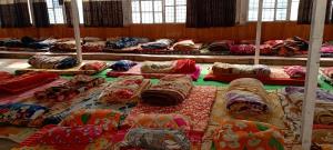 a room filled with lots of pillows and blankets at Himalayan siddhi yog aashram in Badrinath