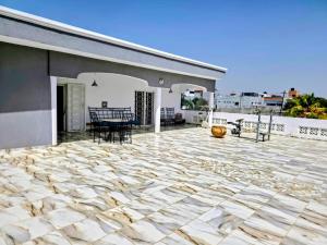 a stone patio with a table and chairs on a house at Villa Ross in Saly Portudal