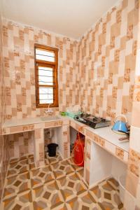 a kitchen with a counter and a sink in a room at Kigwedeni Apartments in Kinyasini +29 photos