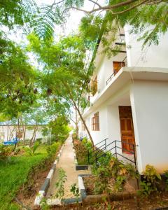 a building with a walkway in front of it at Kigwedeni Apartments in Kinyasini