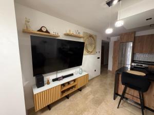 a living room with a large flat screen tv on a wall at Ónice de Riviera 2 in Mijas Costa