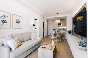 a living room with a couch and a table at REM III Premium Torrevieja in Torrevieja