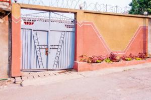ein großes Garagentor mit einer Treppe an der Seite eines Gebäudes in der Unterkunft Residence Mobagnes in Kinshasa