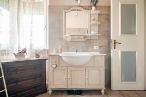 a bathroom with a white sink and a mirror at B&B La Casa di Pamela - 5 min Lago Varese in Varese +23 photos