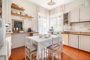 a kitchen with a table with a white table cloth at B&B La Casa di Pamela - 5 min Lago Varese in Varese