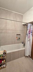 a bathroom with a white tub and a shower at Boyne Place in East Hoathly