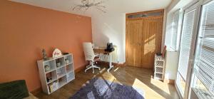 a room with a desk and a wooden door at Boyne Place in East Hoathly +1 photo