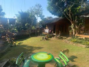 a yard with chairs and a table with a frisbee at Pai yard on Hill in Pai