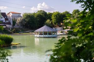 a boat on a river with a tent on it at Bagoly Fogadó in Gyömrő
