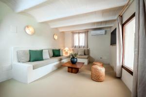 a living room with a couch and a table at Claudia by Nura in Campos