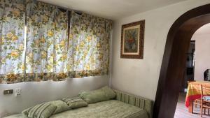 a living room with a couch and a curtain at The Luff & Match B&B in IDRO