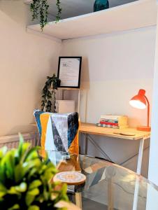 a dining room with a glass table and a desk at Stylish Townhouse - 8 Mins From Leeds - Free Fast WiFi - Free Parking in Headingley