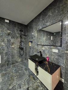 a bathroom with a sink and a mirror at Hotel Arbëri Events in Rahovec +35 photos
