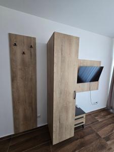 a bedroom with a bunk bed and two wooden cabinets at Hotel Arbëri Events in Rahovec