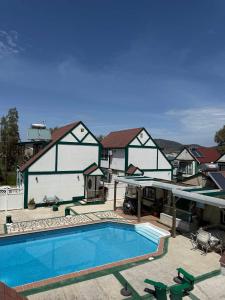 a swimming pool in front of a house at ERV Club - Villas in Lixouri