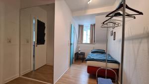 a small room with a bed and a mirror at Natursteinvilla am Goldberg in Hagen