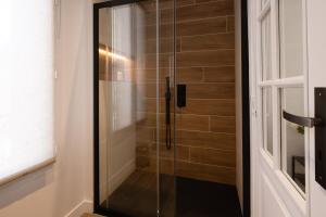 a shower with a glass door in a bathroom at Spacious Designer Duplex 9 Guests Fully Renovated in Châtillon +37 photos