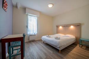 a bedroom with a large bed and a window at Ternélia Henri IV in Clisson +20 photos