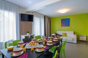 a dining room with a table with food on it at Ternélia Henri IV in Clisson