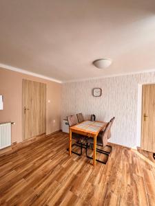 an empty living room with a wooden table and chairs at Northern Panorama in Jílové