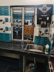 a kitchen counter with a sink in a trailer at 101 Mahalaxmi Homes in Bhubaneshwar