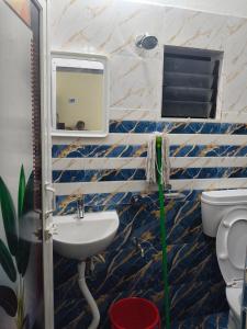 a bathroom with a sink and a toilet at 101 Mahalaxmi Homes in Bhubaneshwar