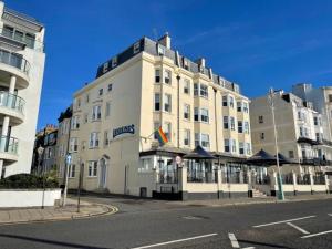 a large white building on the corner of a street at Legends Hotel in Brighton & Hove