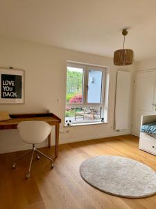 a bedroom with a desk and a bed and a window at Ferienwohnung LANDZEIT in Bad Soden-Salmünster