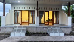 a house with a porch with glass doors at 3Z Homestay in Bayan