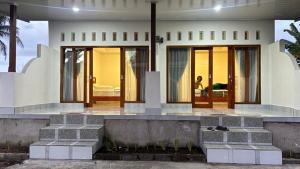 a house with concrete steps in front of it at 3Z Homestay in Bayan +3 photos