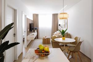 a living room with a table with a bowl of fruit at REM III Premium Torrevieja in Torrevieja