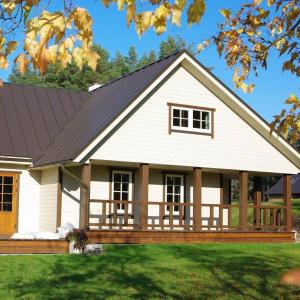 a white house with a black roof at Tabina puhkemaja in Tabina +20 photos