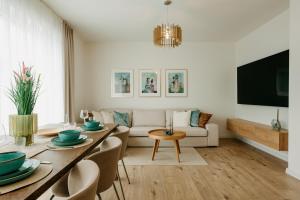 a living room with a table and a couch at Aria Apartments in Prievidza