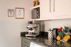 a kitchen counter with a coffee maker on it at Riverside Cottage in Cairngorms in Ballater
