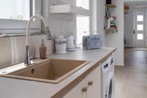 a kitchen with a sink and a counter top at Cosy 21 in Ialysos +22 photos