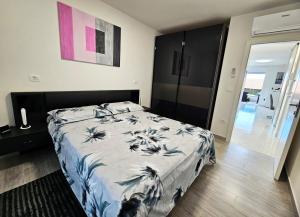 a bedroom with a bed with a blue and white comforter at APP Mary in Novigrad Istria