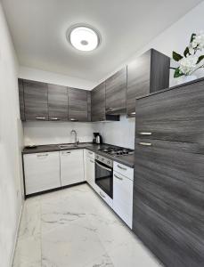 a kitchen with white and brown cabinets and a sink at APP Mary in Novigrad Istria +16 photos