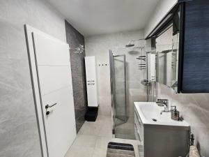 a bathroom with a sink and a shower at APP Mary in Novigrad Istria