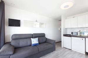 a living room with a couch and a kitchen at Sokoburu Deluxe Beach in Hendaye